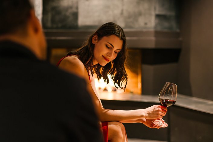 A brunette in front of the fireplace with a sensual look