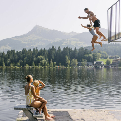 A family enjoys a splash at Schwarzsee