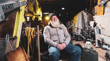 Sigi sitting in a garage