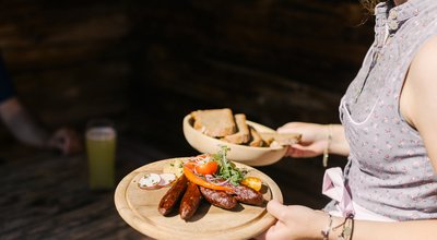 Woman with a snack at a hut in Kitzbühel