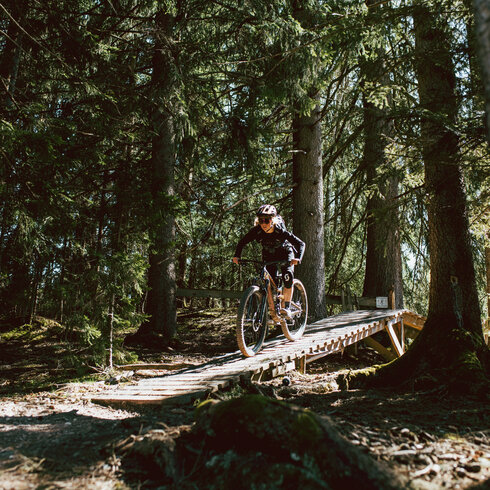 Biker fahren einen Biketrail in Kitzbühel hinunter