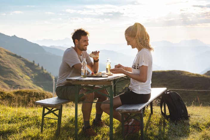Couple enjoying a breakfast in the mountains