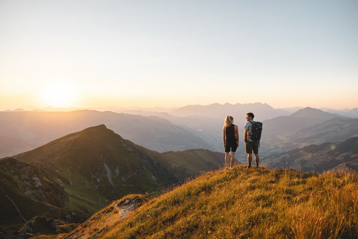 A couple enjoying the view over Kitzbühel while hiking