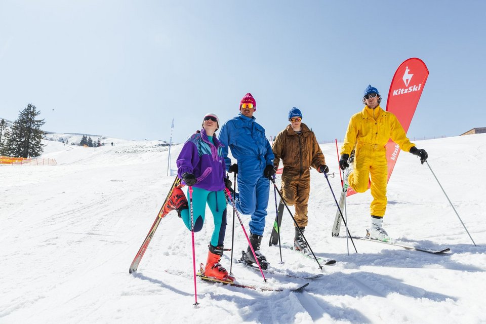 Young people pose on the ski slope