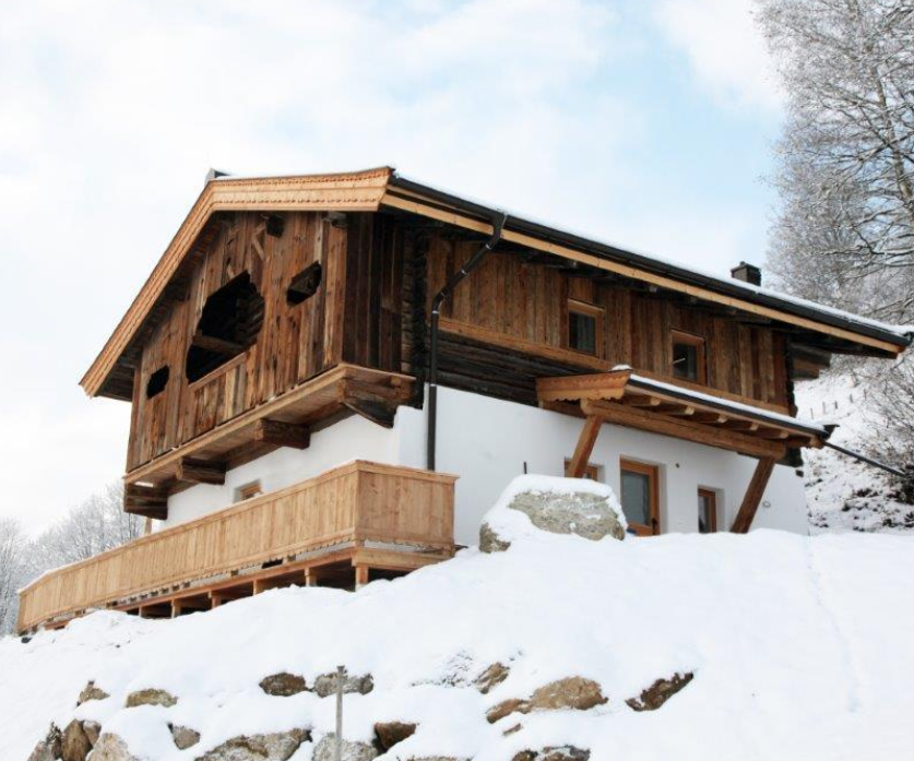 A traditional rustic wooden hut in winter