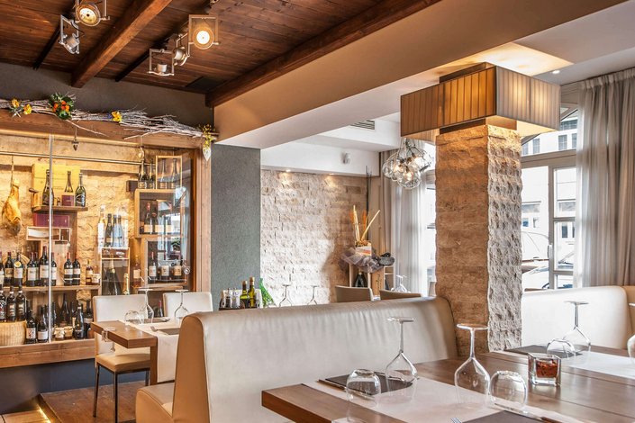Hostaria Kitzbühel Italian restaurant with Mediterranean décor, stones and wine bottles