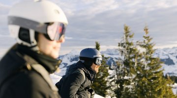 Man and woman enjoy the view while skiing