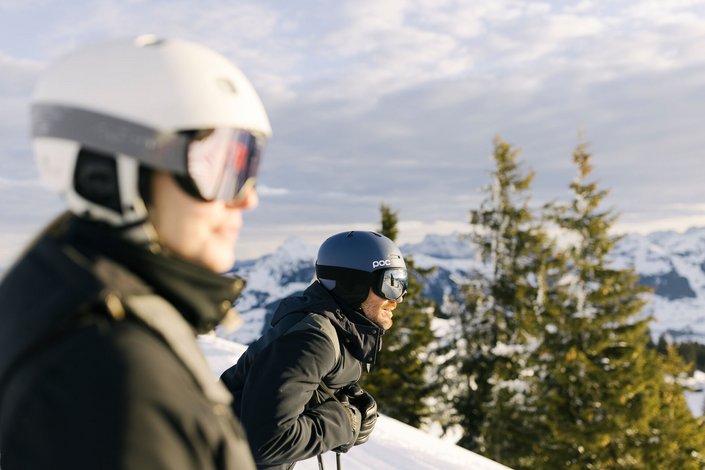 Man and woman enjoy the view while skiing