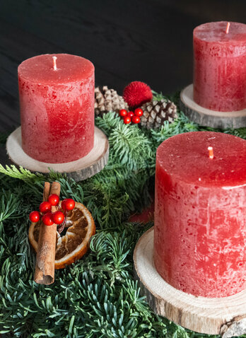 Three red candles on an Advent wreath