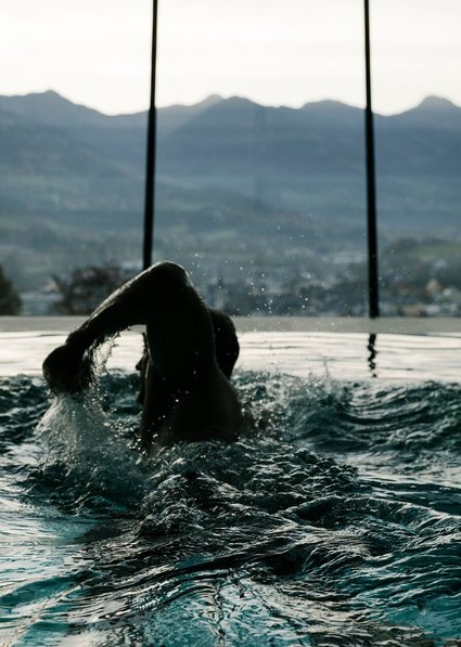 Man swimming in panoramic pool