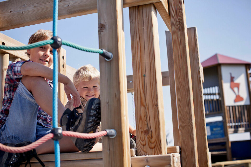 Children are happily playing at a playground in Kitzbühel