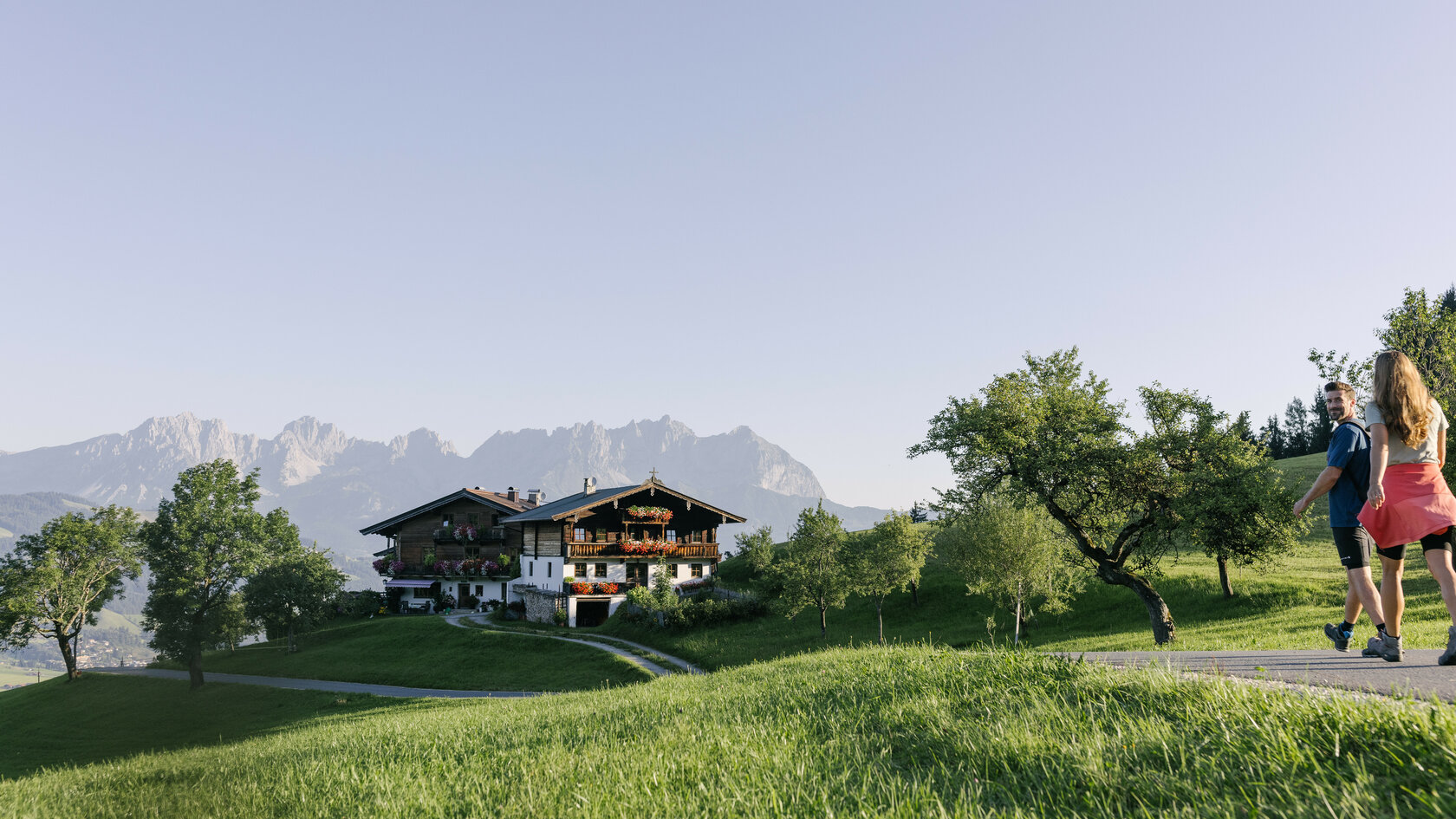 People walking through a meadow in the mountains