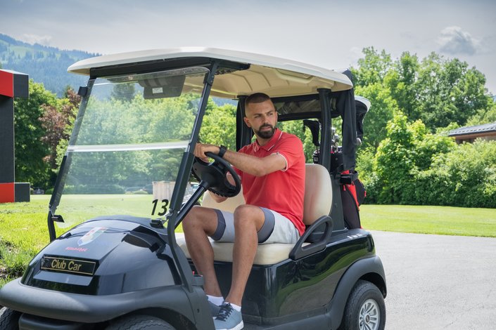 Player in the golf car