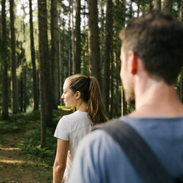 Two people taking a walk in the woods