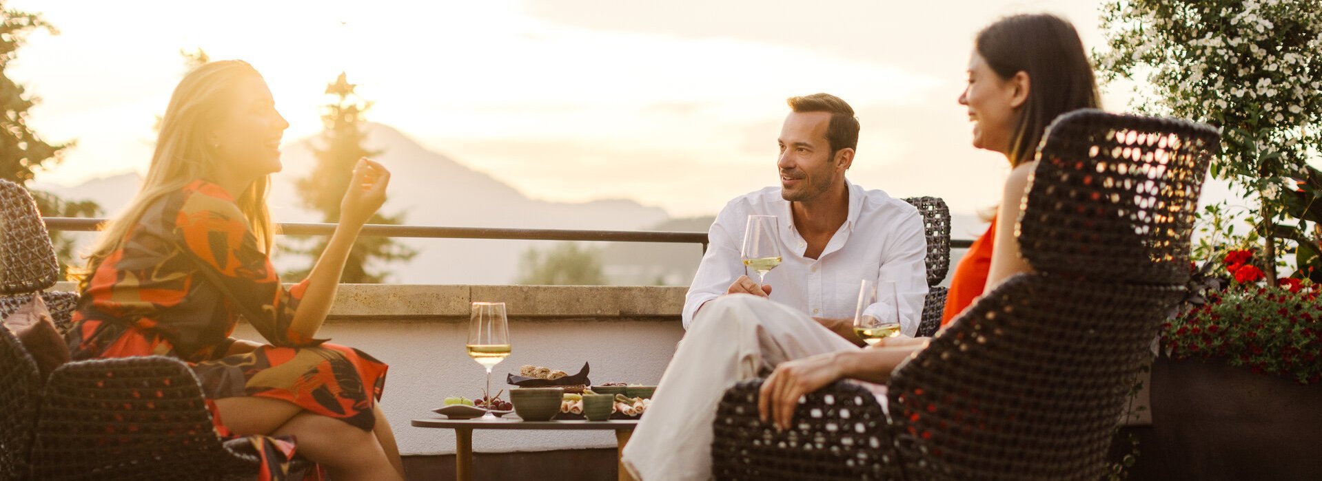 Friends relaxing on a sun terrace in Kitzbühel