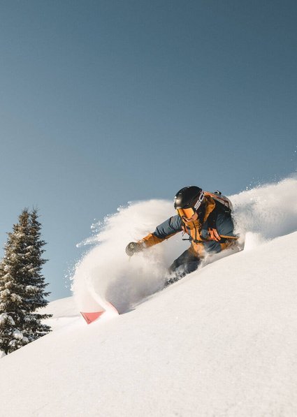 Women skiing in deep powder