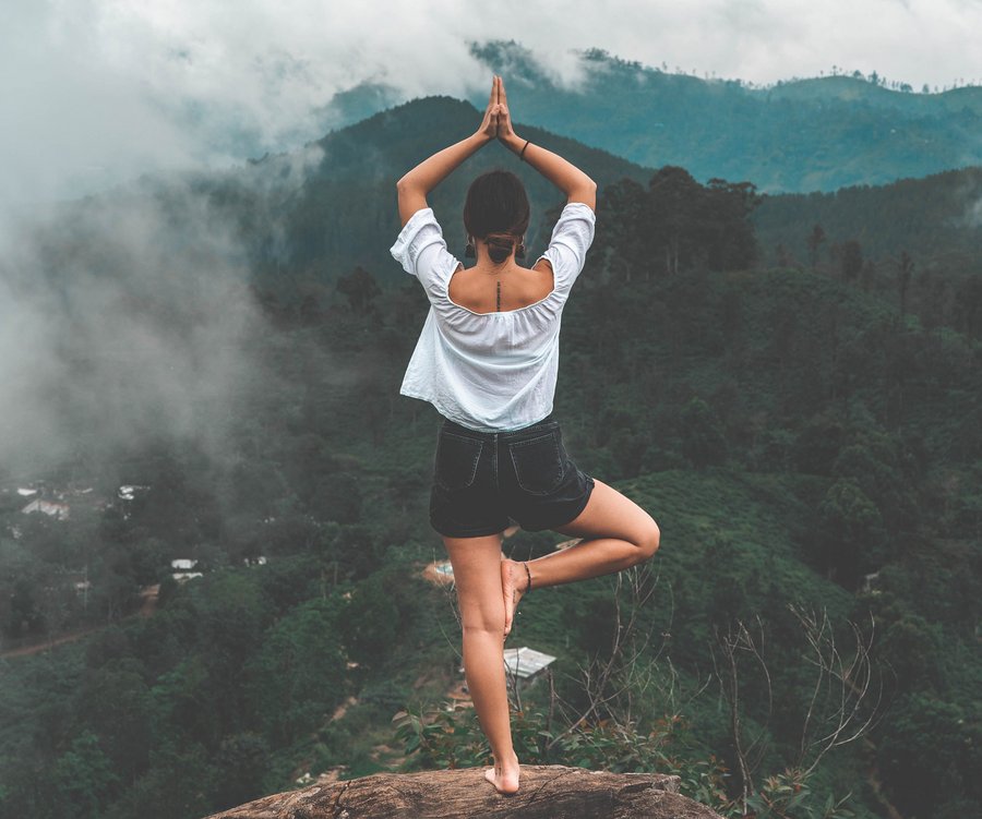 Woman doing yoga on the mountain