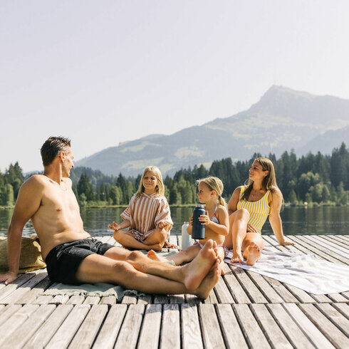 A family playing by the water in Kitzbühel