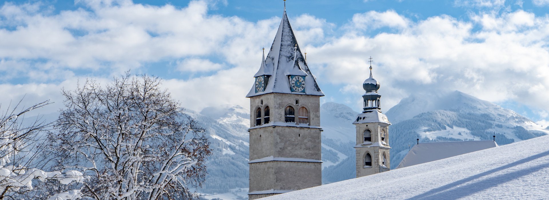 Snowy church with view of Kitzbühel south mountains
