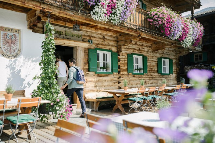 Couple entering a restaurant after hiking