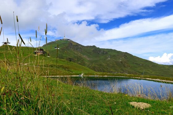 Hornköpflsee mit Kitzbüheler Horn Ein Bergsee im Vordergrund mit Blick auf das Kitzbüheler Horn unter blauem Himmel.