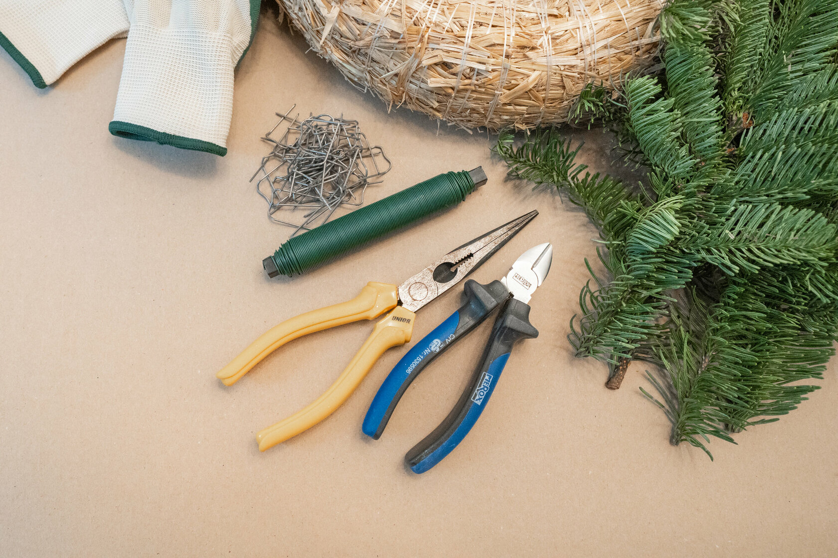 Florist's wire, a pair of pliers, a pair of side cutters, twigs, a straw wreath and needles for making an Advent wreath