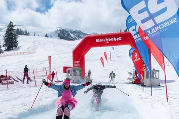 Lady in pink tutu skirt happy at finish after race