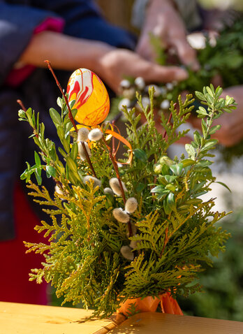 A palm branch with green twigs and catkins