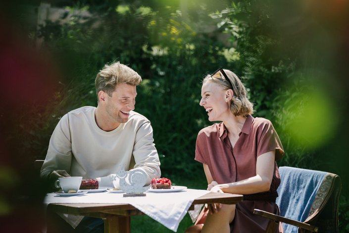 Couple enjoying coffee and cake in a cafe