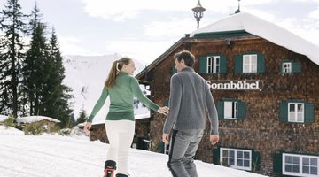 Couple enjoying ski day at ski hut