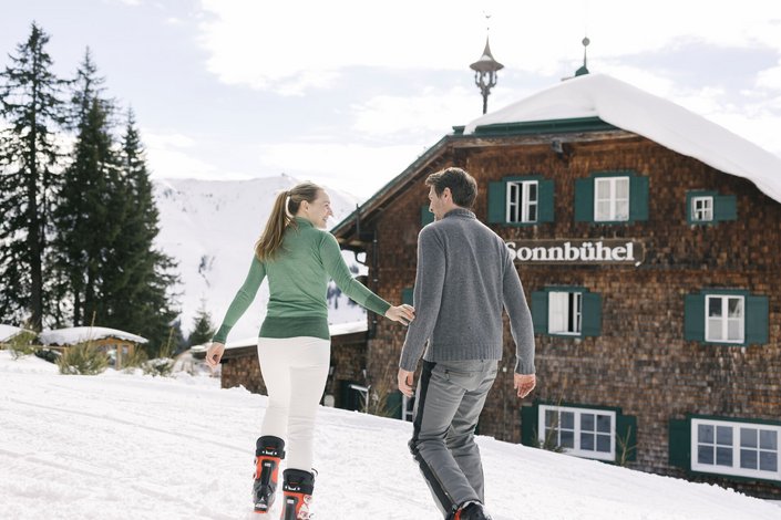 Couple enjoying ski day at ski hut