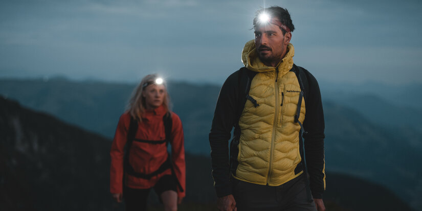 Two people are walking at dusk