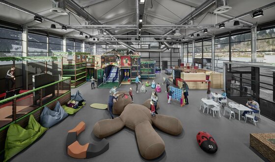 Großer Indoor-Spielplatz mit Klettergerüsten, Rutschen, Sitzsäcken und spielenden Kindern in einer modernen Halle.