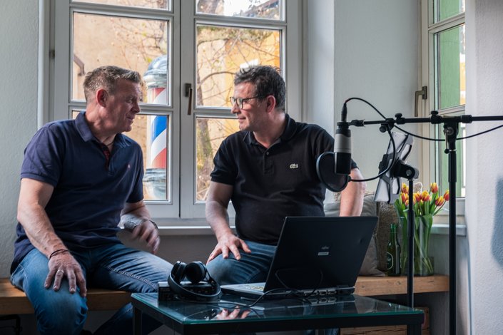 Two men in front of the window