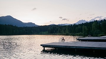 evening view by the black lake in kitzbuehel 