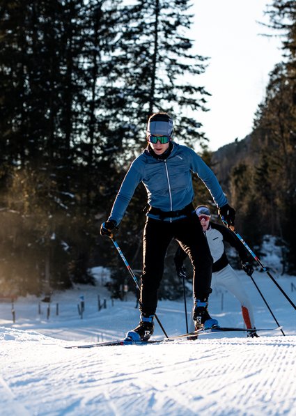 A couple goes cross country skiing